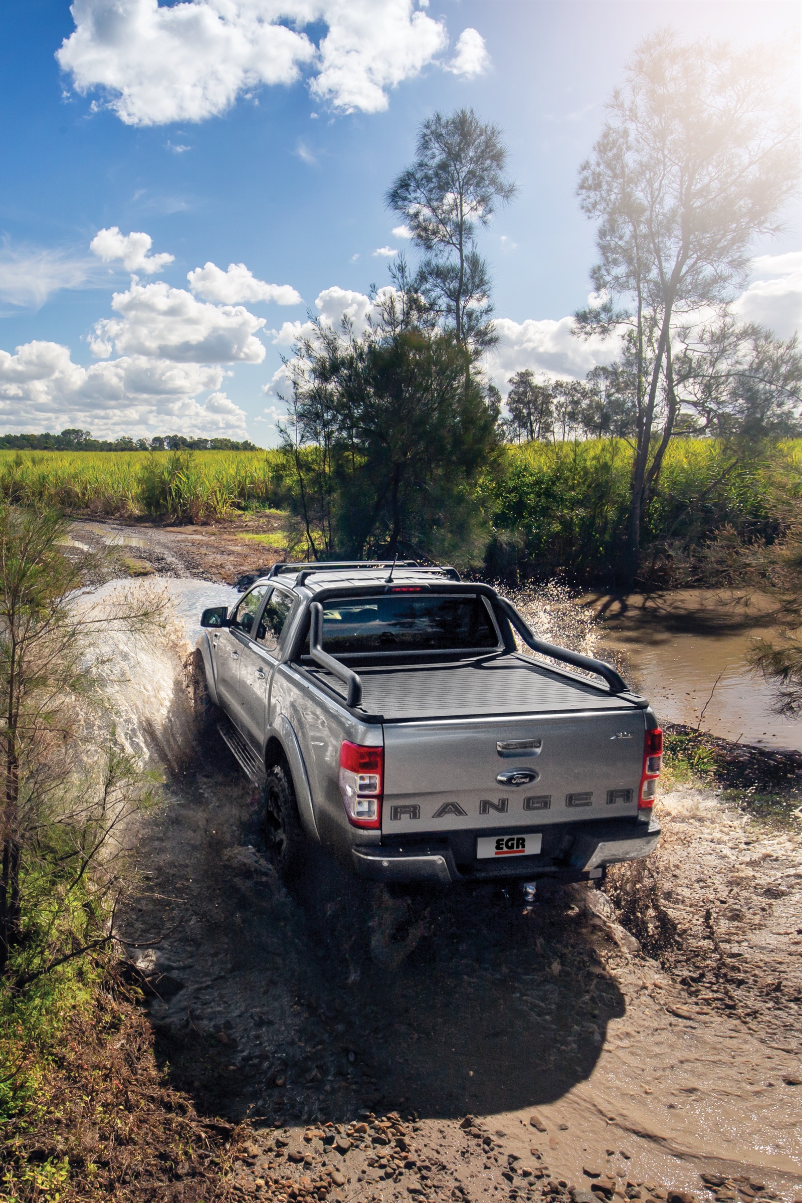Ford Ranger with an EGR RollTrac tonneau cover crossing a creek